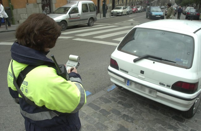 controlador de parqu&iacute;metro poniendo multa